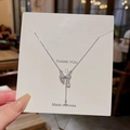 Close-up of silver bow pendant necklace with crystal detail on a thank you card - Bowknot Tassel Pendant (X1173) / Silver/Clear Crystal