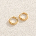 Elegant gold round earrings with clear zircon stones on a beige textured background - Five-pointed Star Zirconia (ES2277)