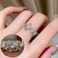 Vintage silver hollow flower ring with white zircon stones worn on hand - Four Petal Flower Zircon Eternity(JZ7971)
