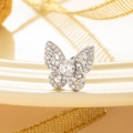 Silver butterfly stud earring with clear cubic zirconia on soft textured background - White