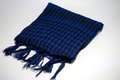 Close-up of blue and black checkered desert scarf with fringe detail on white background - Sapphire Blue
