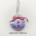 Detailed view of purple embroidered lucky charm sachet with tassel and silk ribbon bow - Peace (Chain Version) / Purple
