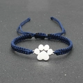 Macro shot of blue hand-woven adjustable rope bracelet with silver dog paw print charm - Navy Blue