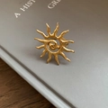 Exaggerated golden sunburst ring with a spiral center and hammered metal texture - Sun Spiral (TR126) / Gold