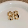 Elegant gold double interlocking geometric loop earrings displayed on ceramic tray - Interlocked Hoop Chain Earrings / Gold