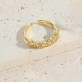 Golden open cross ring with clear zircons on beige marble textured background - Clear Zirconia Style