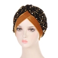 Ginger and black velvet turban headwear with golden sequins shown on a mannequin head - Camel