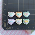 Macro shot of 6 mixed-color resin heart charms with bows on a cm scale cutting mat - Bow Heart Mixed Colors