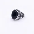 Detail of Style K vintage men's ring with black oval stone and engraved titanium steel - Style K