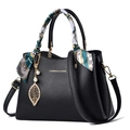 Elegant black leather tote bag with silk scarf handle and pearl leaf charm accessories - Black With Green Scarf