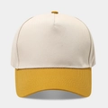Detail of five-panel baseball cap showing beige crown and yellow visor with stitching - Beige Splicing Yellow