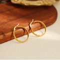 Detail of gold twisted hoop earrings with textured finish on a wooden display tray - Twisted Texture Hoop Earrings(ZHE1428金)