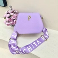 Detail of purple trapezoid tote bag with gold P emblem and branded wide shoulder strap - Purple