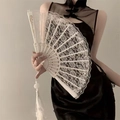 Elegant white lace folding fan with decorative tassel held by woman in black qipao - Lace Folding Fan White With Pendant (No Feather)