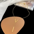 Elegant gold-tone Y-shaped titanium necklace featuring a V-pendant and vertical bar drop - AH369 Letter V Pendant Gold