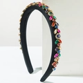 Close-up of luxury black satin headband with colorful rhinestones and diverse gemstones - Colorful