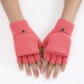 Detail of pink knitted fingerless gloves with a practical flip cover and button closure - One Size / Dusky Pink