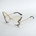 Exaggerated butterfly sunglasses detail shot, rhinestone rimless design with chic chain temples. - Gradient Yellow