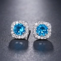Elegant halo stud earrings featuring round sea blue cubic zirconia in silver setting - Lake Blue