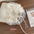 Elegant white floral scrunchie with lace edge detail and ribbon on wooden tray - White