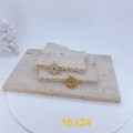 Detail of gold-plated sun-shaped pendants with evil eye inlay and sunburst texture - Full Zircon Sun Evil Eye