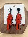 Detail of red and black acrylic earrings featuring a romantic silhouette on a wood surface - Couple Silhouette