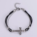 Detail of double-layer titanium steel bracelet featuring a crystal cross and black rope - Silver