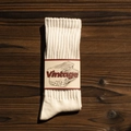 Vintage style white cotton knit crew socks with paper wrap on dark wood background - One Size(EU 35-44) / White