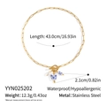 Macro view of stainless steel toggle clasp necklace with ceramic heart and pearl pendant - Gold