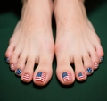 Detailed view of American flag style press-on toenails with white stars and red stripes - Style FW62 (With Yellow Jelly Glue + File)