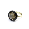Detail of an adjustable gold ring with a grey faceted gemstone and black halo detail - Labradorite