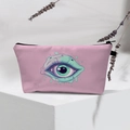 Pink Evil Eye makeup bag with green illustration on white stand with lavender - Pink Monster Eye