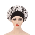 Floral print satin bonnet with black wide elastic band on a mannequin head - One Size / Black