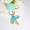 Letter K keychain with blue resin stone, gold glitter, and mint green pompom accessory - Letter K