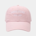 Detail showing the intricate white LOVE STORY embroidery on pink cotton baseball cap - Adjustable / Pink