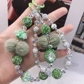 Handmade green beaded phone strap with rhinestone balls, fur pom-poms and floral beads - Green Rose