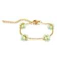 Detailed shot of handmade bohemian beaded flower bracelet with mint green beads and gold chain - Fruit Green