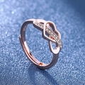 Rose gold infinite heart ring with small zircon stones on a shimmering blue background - Rose Gold Ljz-207 / Adjustable Open