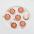 Macro detail of daisy alloy pendants with red and yellow oil drip finish for DIY crafts - Red