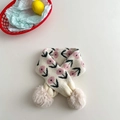 Detail of knit children scarf featuring pink flower patterns and brown pom-poms - White Pink Flower