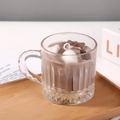 Vertical glass jar candle with coffee brown base and dessert marshmallow top design - Style 1