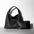 Black woven leather bucket bag set with matching small pouch in minimalist studio style - Black