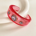 Detail of pink resin cuff bracelet with purple crystals and gold sparkling rhinestones - Magenta Base with Light Purple Zirconia