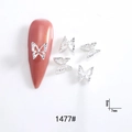 Macro shot of 7mm silver hollow metal bow nail charms showing model 1477 details - 1477# Silver Hollow Butterfly