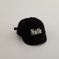 Detail of white NwDie 3D embroidery on a black cotton twill baseball cap for kids - 48-50cm / Black