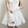 Detailed view of white knitted arm sleeves featuring cute pink ribbon bows and lace edges - White Base Pink Bow