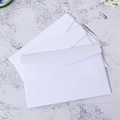Stack of white paper envelopes on gray stone background with decorative flowers - White Envelope / 15.5x10.5cm