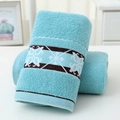 Light blue cotton towel featuring decorative brown and white geometric jacquard pattern - Cotton Flower Bloom Blue (Towel)