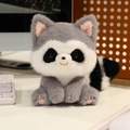 Cute plush raccoon stuffed animal toy with fluffy tail on a warm desktop background - Raccoon Sitting Style