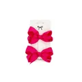 Macro detail of two bright rose pink grosgrain ribbon bow hair clips on a display card - Rose Red